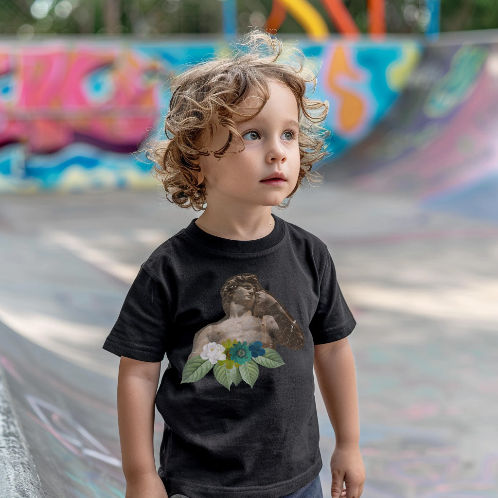 a little boy standing in front of a skateboard ramp