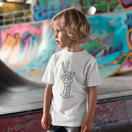 a little boy standing in front of a skateboard ramp