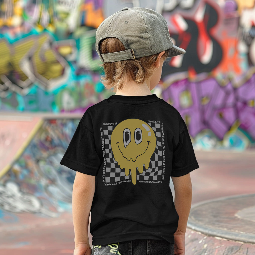 a young boy standing in front of a skateboard ramp